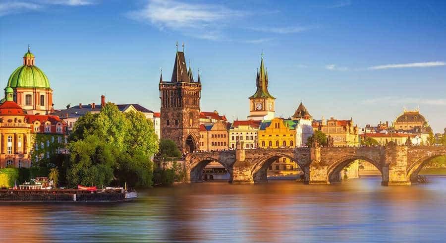 Charles Bridge is a medieval stone arch bridge that crosses the Vltava river in Prague